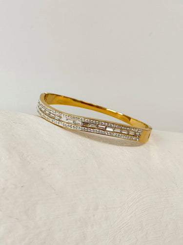 Gold stainless steel bangle bracelet with pavé crystal details on neutral background – Matte Jewelry