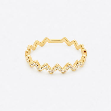 Mia Ring gold zigzag band with pavé stones front view on light neutral background showing geometric wave silhouette and delicate sparkle