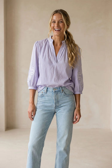 Mirko Blouse soft lavender blouse styled with light-wash jeans full-body front view.