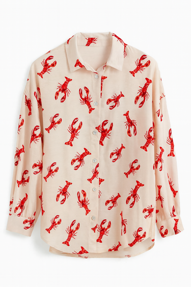 Beige shirt with red lobster pattern on a white background