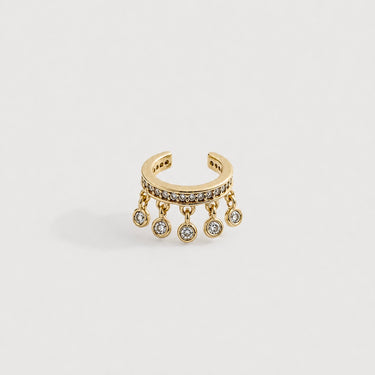 Modena Ear Cuff in polished gold featuring a pavé crystal band with delicate dangling crystal charms, designed as a sparkling statement ear cuff on a clean neutral background.