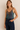 Muna Sequin Top — satin camisole in iridescent teal with bronze sequin neckline, worn by model against neutral wall, Matte Clothing Collection.