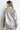 Silver foil-finish oversized denim jacket with textured sheen and relaxed silhouette, shown from back views — Narat Oversized Jacket.