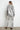 “Silver foil-finish oversized denim jacket with textured sheen and relaxed silhouette, shown from back view — Narat Oversized Jacket.”