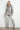 Oversized silver metallic denim jacket with glossy finish and relaxed fit, shown on model styled with matching silver pants — Narat Oversized Denim Jacket by Matte.