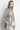 Oversized silver metallic denim jacket with glossy finish and relaxed fit, shown on model styled with matching silver pants — Narat Oversized Denim Jacket by Matte.