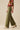 Nerina Pant – olive green wide-leg pants side view showing relaxed fit and drape.