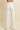 Nurcia Jeans back view showing high-rise waistband, relaxed wide-leg fit, and clean minimal back silhouette in off-white denim.