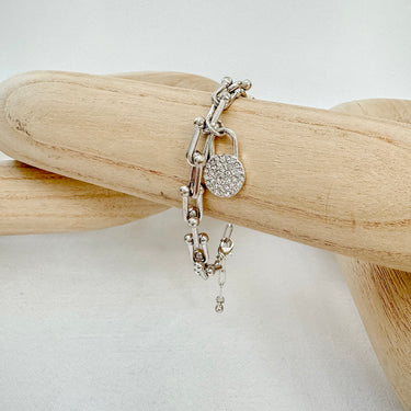 Silver lock chain bracelet on wooden display — Odette Bracelet by Matte.