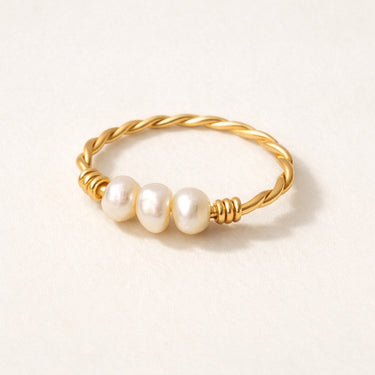 Gold twisted wire ring with three freshwater pearls on a soft neutral background, Olivia pearl ring minimalist gold jewelry.