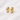 Orix Huggie Earrings – chunky gold huggie earrings with a smooth polished gold finish, photographed on a soft neutral background.
