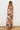 Otti Maxi Dress strapless leaf print maxi dress side view showing flowy relaxed silhouette.