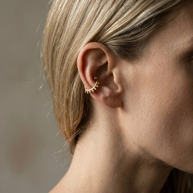 Pordenone Ear Cuff gold minimalist ear cuff on model ear with modern sculptural design