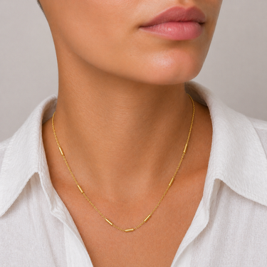 Quirk Necklace delicate gold chain necklace with a fine minimalist design, featuring small subtle bar accents spaced along the chain for a layered look