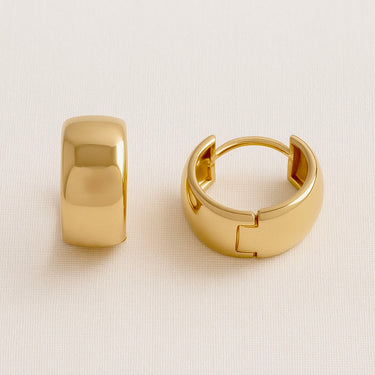 Close-up of Renne Huggie Earrings highlighting smooth curved surface and hinge closure
