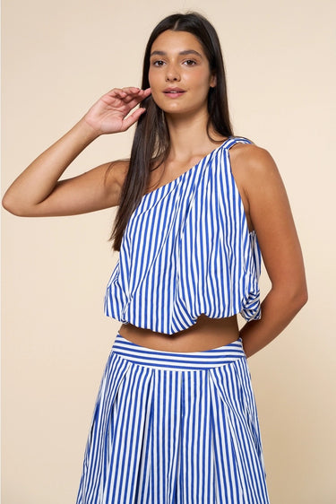 Ritzi Blouse front detail of vertical blue stripes, soft drape one shoulder crop top on model