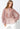 Model wearing Selene Metallic Blouse in rose metallic pleated fabric with button-down closure and long sleeves.