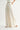 Rumi Pant cream wide-leg trousers side profile view showing flowing drape and relaxed elegant leg line.