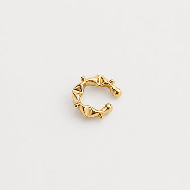 Sculptra Ear Cuff in polished gold featuring a sculptural open silhouette with raised stud details and smooth high-shine curves, designed as a bold modern statement ear cuff on a clean neutral background.