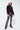 Shimmering black sequin flare pants styled with a casual sweatshirt, statement night-out look by Matte