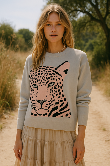 Woman wearing a sweater with a pink leopard design in a natural setting