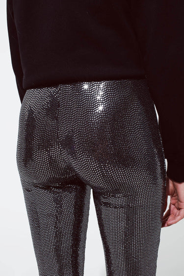 Back view of black sequin flare pants with flattering fit and metallic shine, statement partywear bottoms