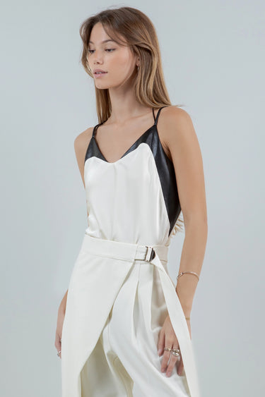 Model wearing the Lennon two-tone ivory satin cami with black faux-leather accents, slightly to the side.