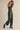 Model wearing the Melina strapless jumpsuit with relaxed straight-leg silhouette, side view.