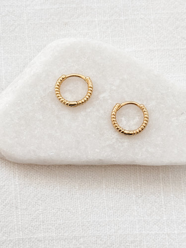 Silva Huggie Earrings — beaded gold plated huggies on white linen background, delicate, lightweight, and timeless jewelry by Matte.