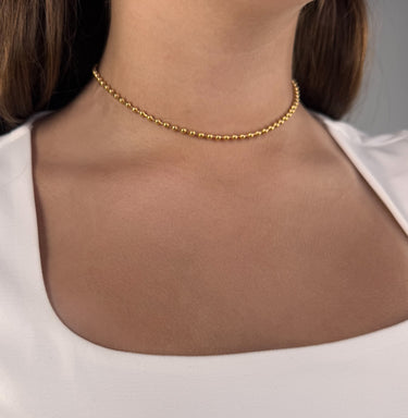 Model wearing Sunbeam Necklace by Matte, gold filled beaded chain, 14 inch choker
