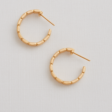 Syra Hoop Earrings — gold plated linked hoop earrings with modern design on linen background, polished and elegant jewelry by Matte.