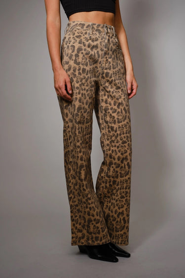 High-rise leopard-print jeans with subtle studded accents and wide-leg silhouette, photographed in soft natural light on a neutral background.