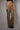 High-rise leopard-print jeans with subtle studded accents and wide-leg silhouette, photographed in soft natural light on a neutral background.
