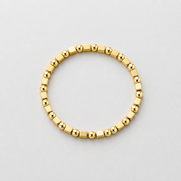Talte Bracelet gold beaded stretch bracelet on neutral background, showing rounded and squared polished beads and easy slip-on design
