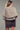 Back view of knit cape cardigan showing relaxed drape and ribbed hem.