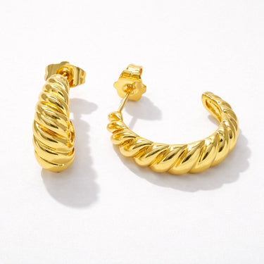Tiru Hoop Earrings gold rope textured hoop earrings with twisted sculptural design isolated on light background.