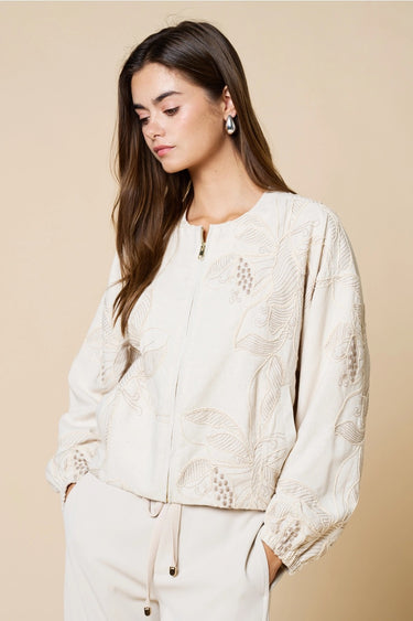 Tuci Jacket worn by model, angled view, showing tonal embroidery and lightweight structured fit.