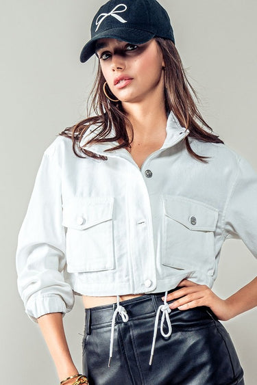 White cropped utility jacket with front pockets, styled casually