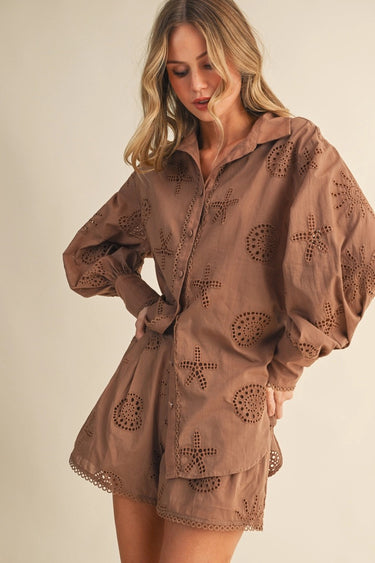 Woman wearing a brown outfit with cut-out designs on a beige background