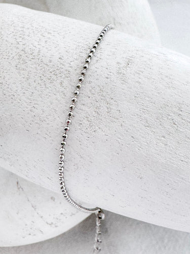 Silver beaded bracelet on white marble background – Atina Bracelet