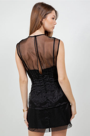 Wada Top worn by model, back view, showing sheer mesh upper and fitted silhouette.