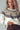 Close-up of Zermatt Sweater yoke, fair isle knit in cream, taupe, and brown with ribbed neckline.