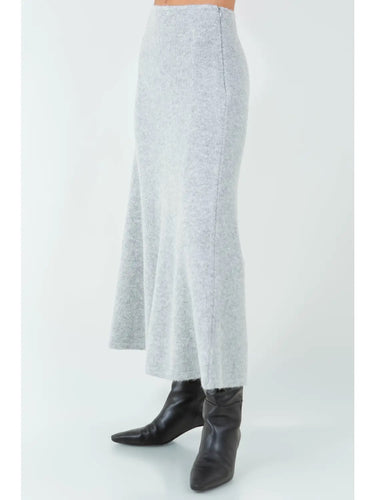 Full-length view of the Aero knit maxi skirt styled with black boots.
