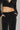 Model wearing Akima Pant in black velvet with high waist and relaxed wide-leg silhouette.