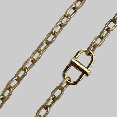 Allison necklace by Matte, gold plated chain necklace with 18″ length displayed on stone background