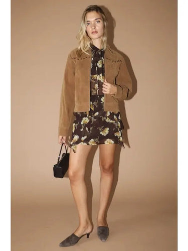 Model wearing the Amirk Jacket over a black floral mini dress, showing the full outfit styling and versatile day-to-night look.