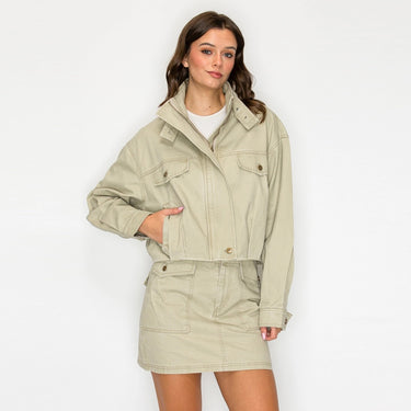 Model wearing the Amurai Utility Cropped Jacket in light khaki with a relaxed fit and flap pockets.