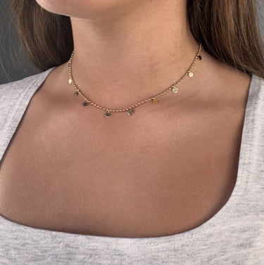 Model wearing Aria Necklace by Matte, gold plated beaded necklace with disc charms, 14 inch choker style
