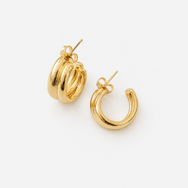 Artsy Hoop Earrings featuring polished gold-plated double-band hoop earrings with a sculptural layered design, rounded high-shine finish, lightweight construction, secure post-back closure, and a bold contemporary silhouette.