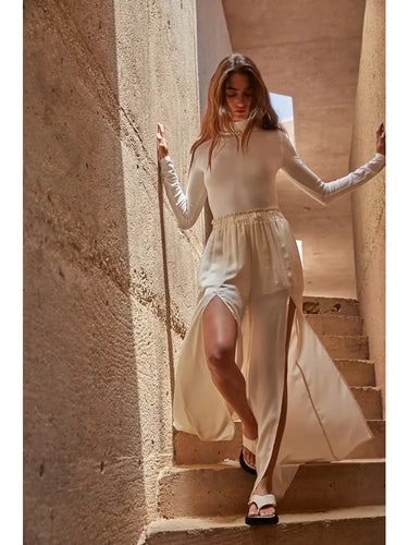 Askett Bodysuit styled with a flowing skirt showcasing its sleek fitted silhouette.